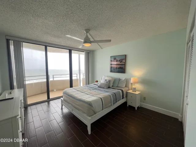 a view of a room with wooden floor and a hallway