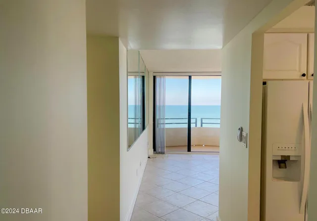a living room with furniture and a floor to ceiling window