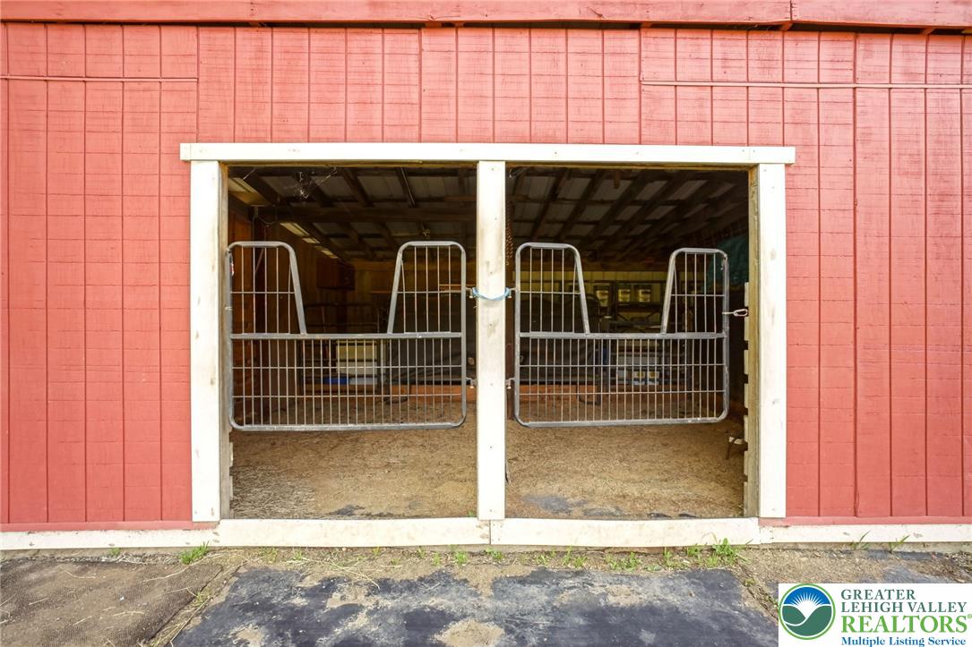 9033 Loop Road Slatington, PA 18080 - Photo 11 of 53 Secure stalls welcome equine residents in this well-maintained barn, offering comfort and functionality.