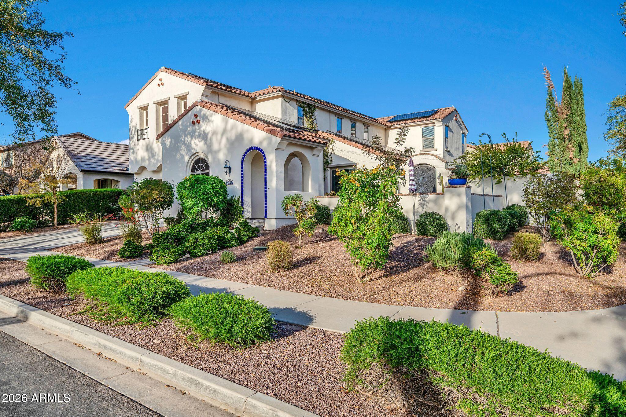 2985 North Point Ridge Road Buckeye, AZ 85396 - Photo 31 of 107 a front view of a house with a yard and potted plants