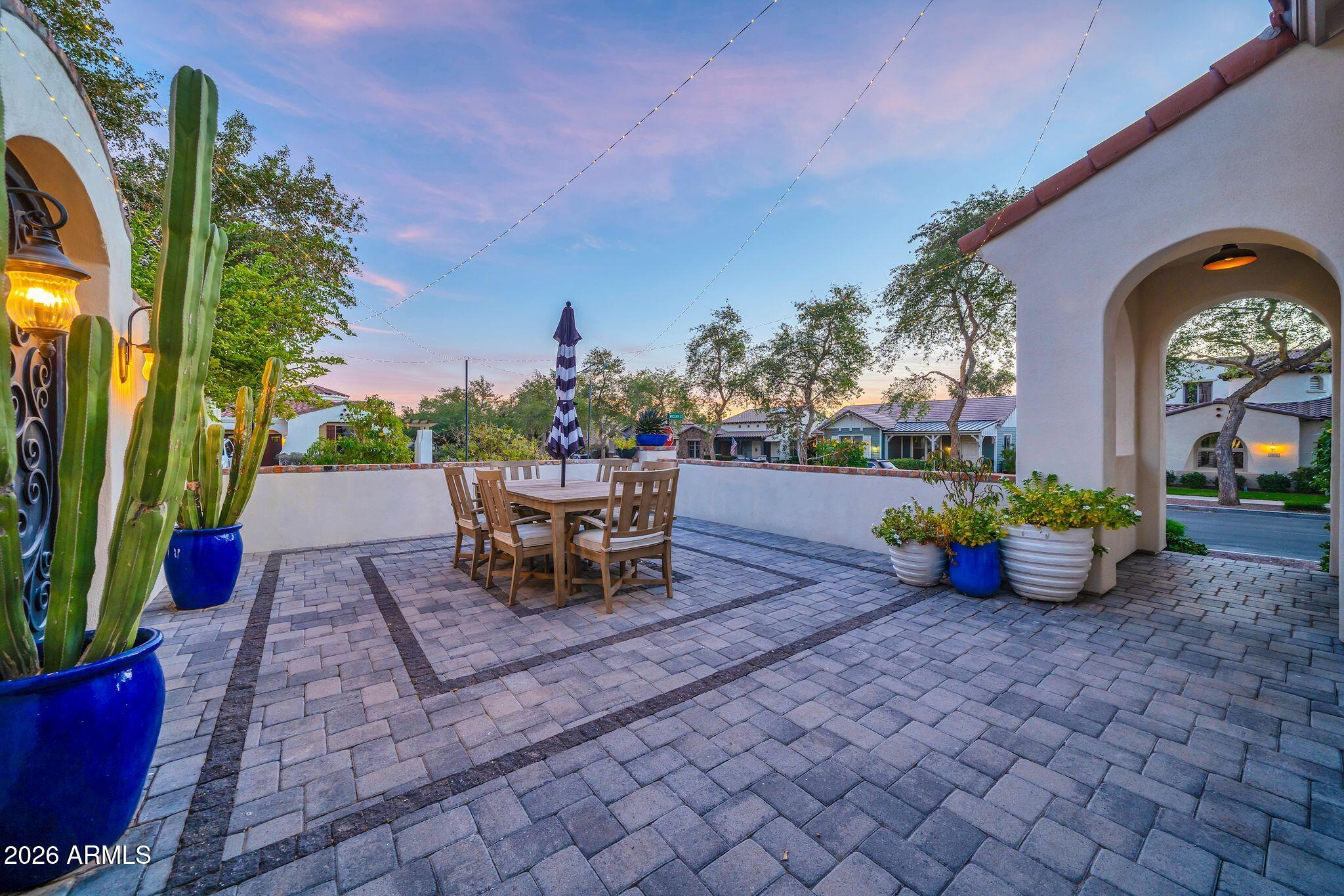2985 North Point Ridge Road Buckeye, AZ 85396 - Photo 34 of 107 a view of a patio with table and chairs potted plants with sky view