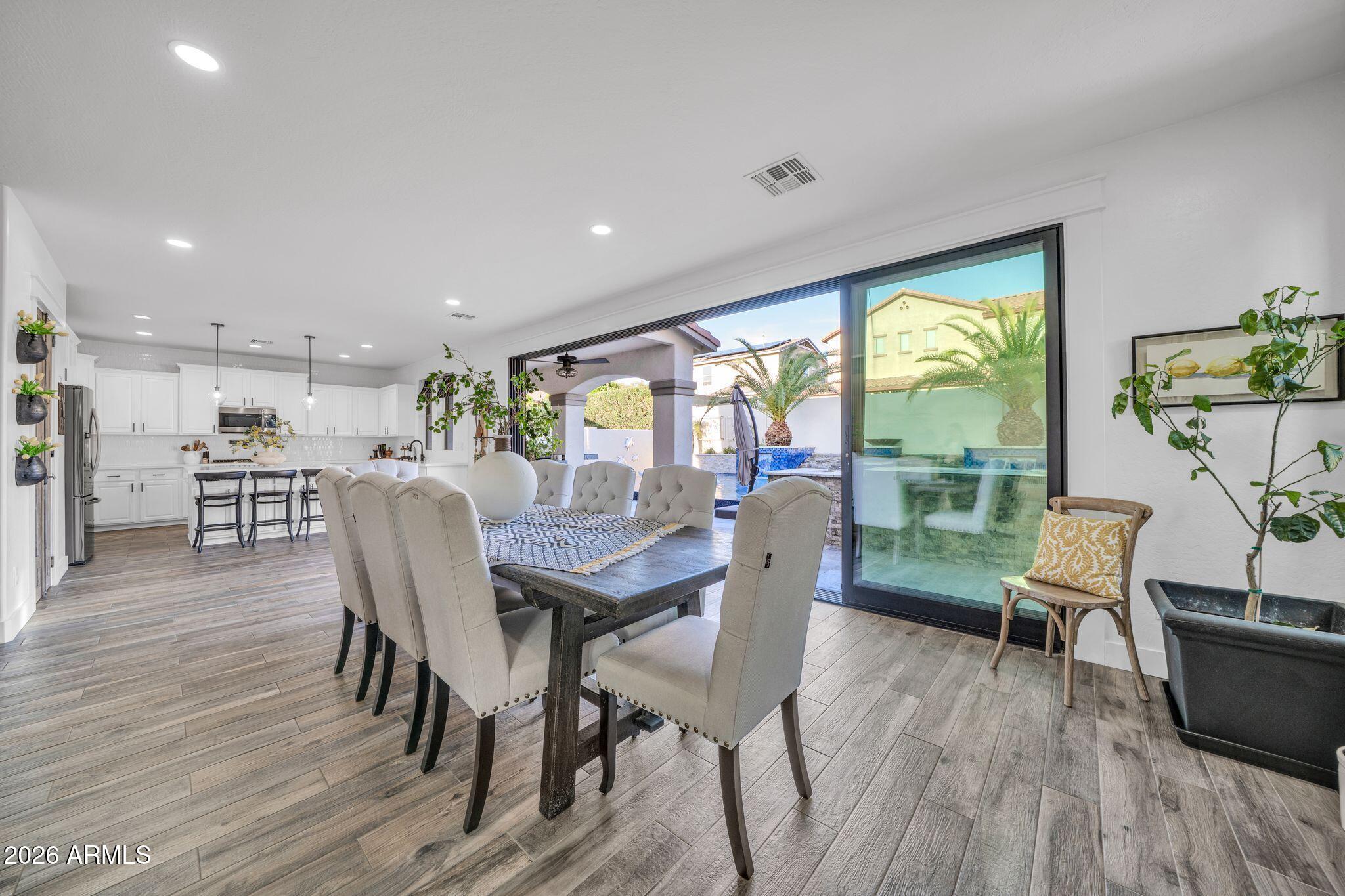 2985 North Point Ridge Road Buckeye, AZ 85396 - Photo 40 of 107 a view of a dining room with furniture window and wooden floor
