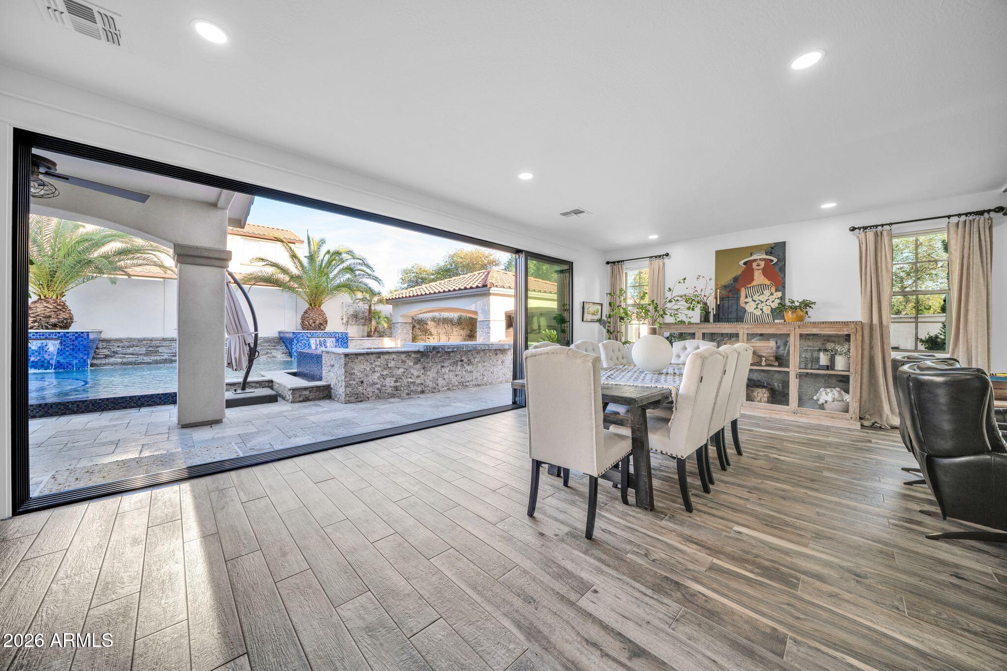 2985 North Point Ridge Road Buckeye, AZ 85396 - Photo 41 of 107 a dining room with furniture and wooden floor