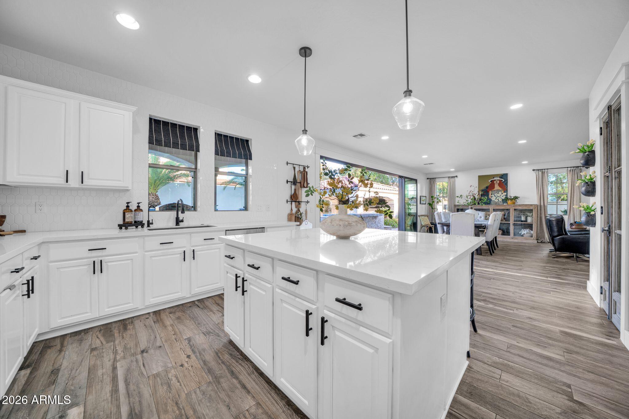 2985 North Point Ridge Road Buckeye, AZ 85396 - Photo 52 of 107 a kitchen with stainless steel appliances kitchen island granite countertop a large island in the center