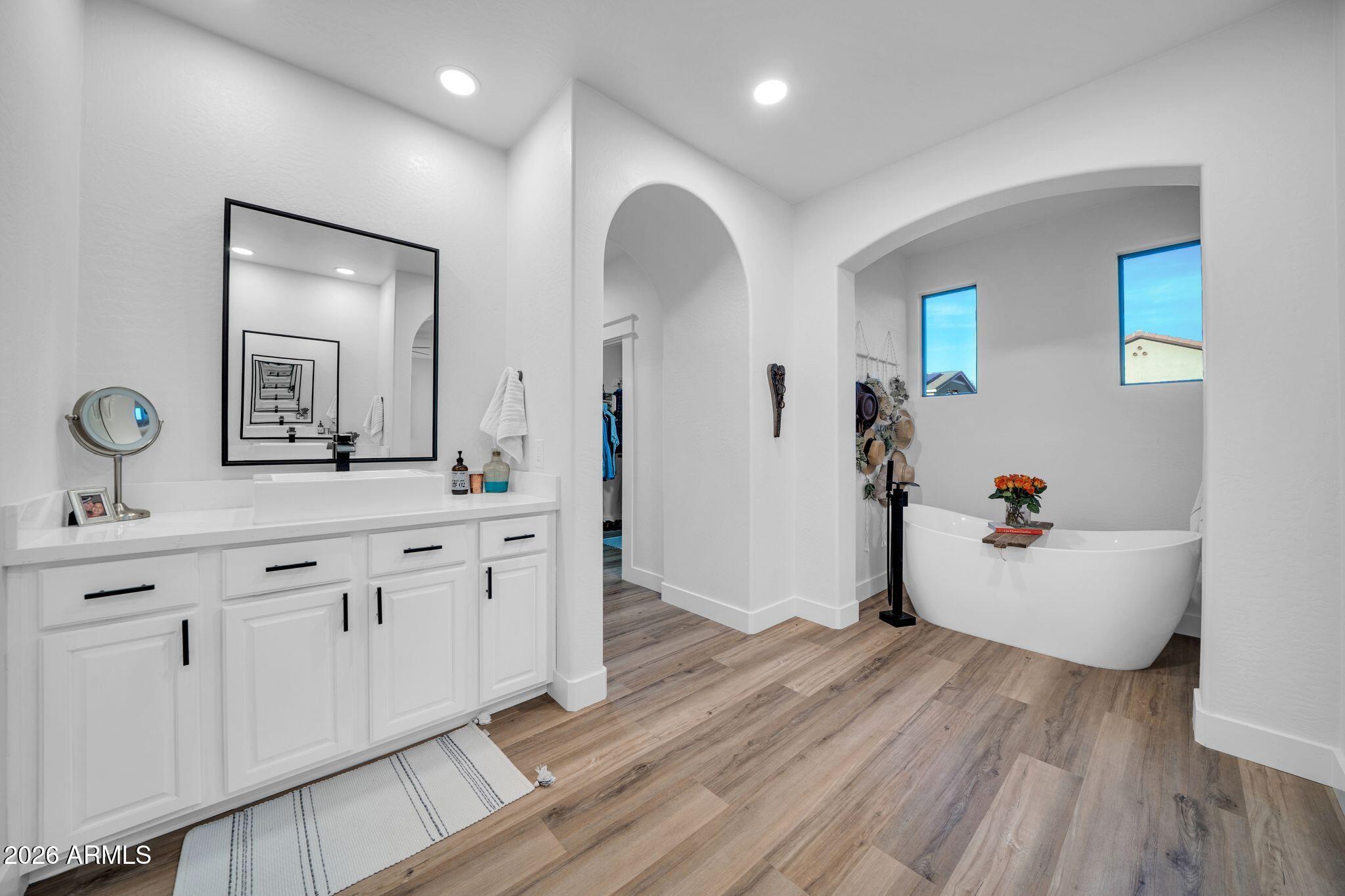 2985 North Point Ridge Road Buckeye, AZ 85396 - Photo 59 of 107 a view of a bathroom with a sink mirror and wooden floor