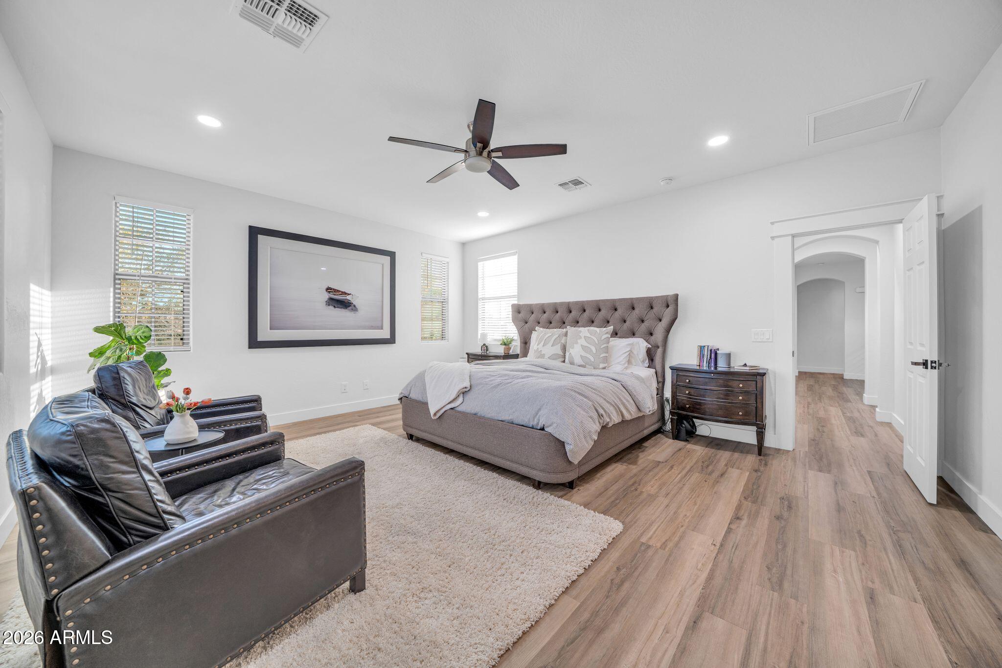 2985 North Point Ridge Road Buckeye, AZ 85396 - Photo 62 of 107 a bedroom with a bed couch and a window