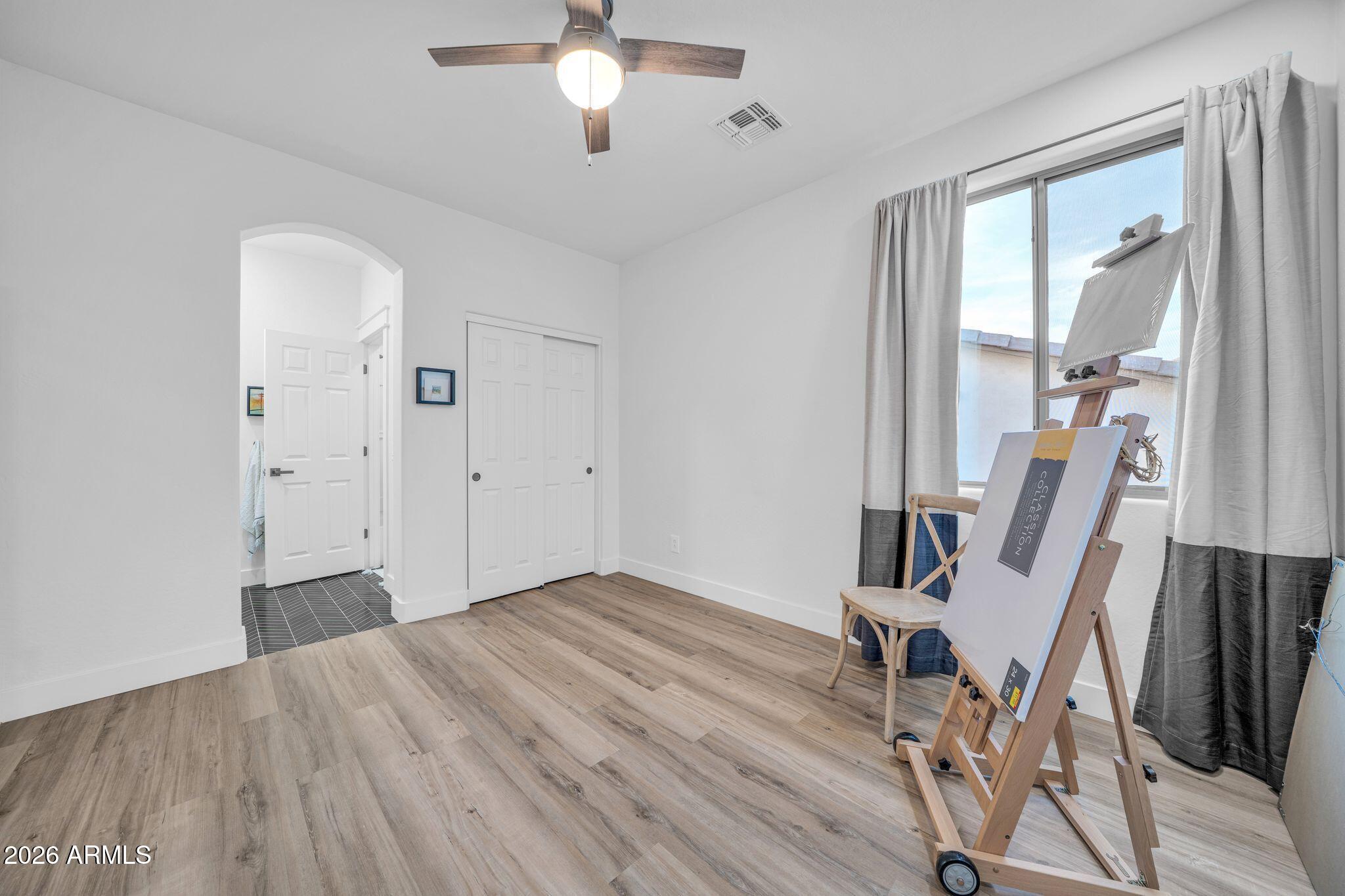 2985 North Point Ridge Road Buckeye, AZ 85396 - Photo 64 of 107 a view of an empty room with wooden floor and a window