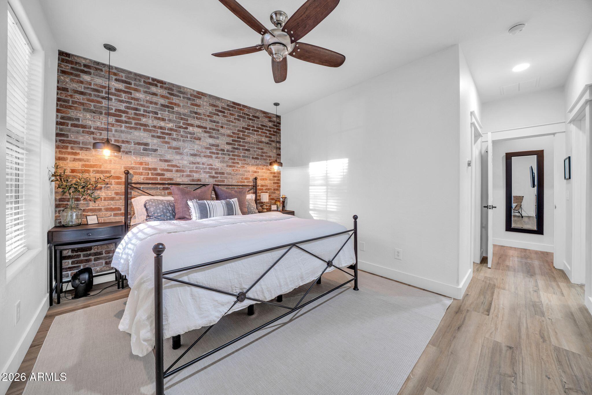 2985 North Point Ridge Road Buckeye, AZ 85396 - Photo 70 of 107 a bedroom with a bed and a ceiling fan