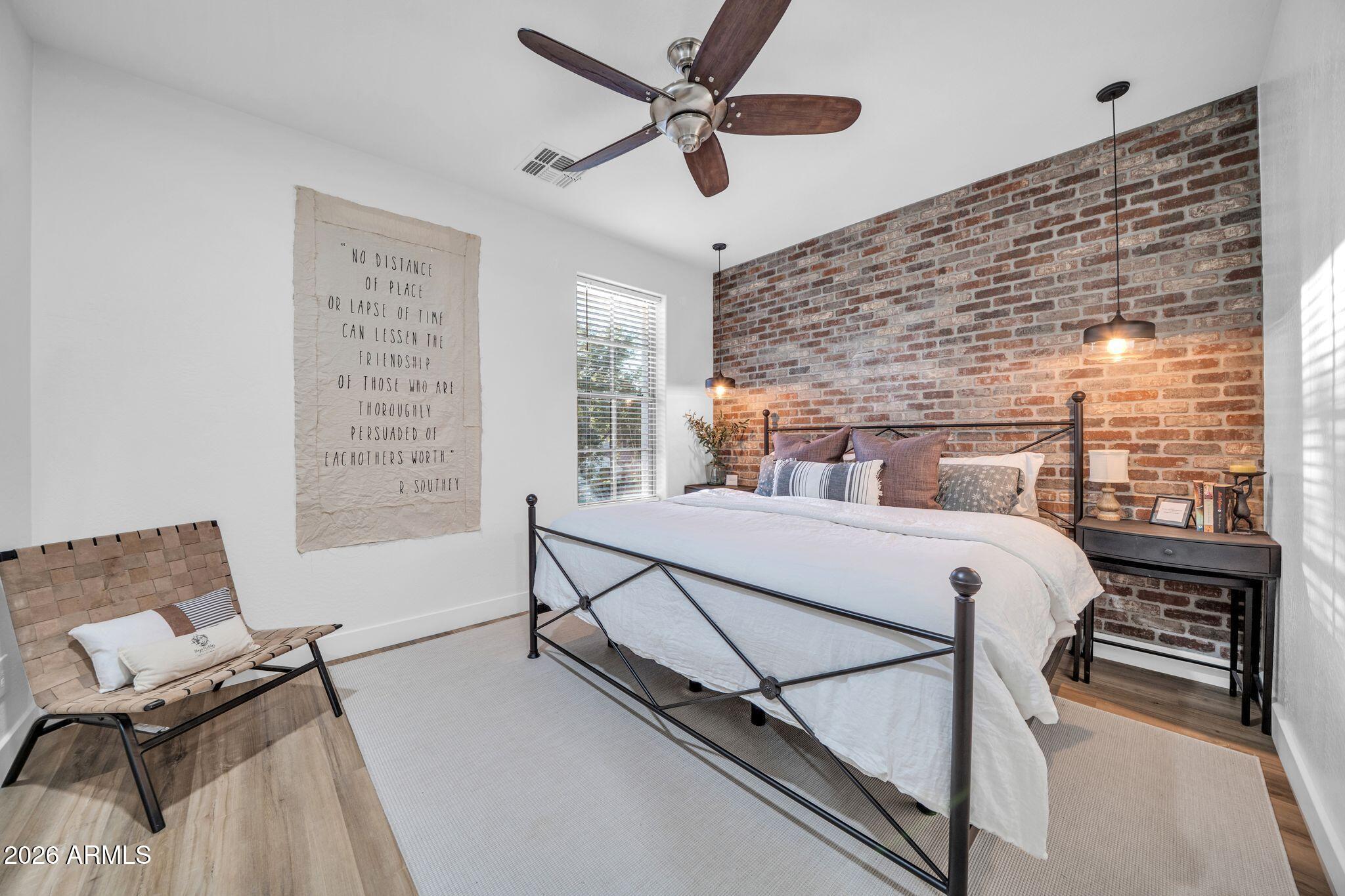 2985 North Point Ridge Road Buckeye, AZ 85396 - Photo 71 of 107 a bedroom with a bed a dresser next to a window