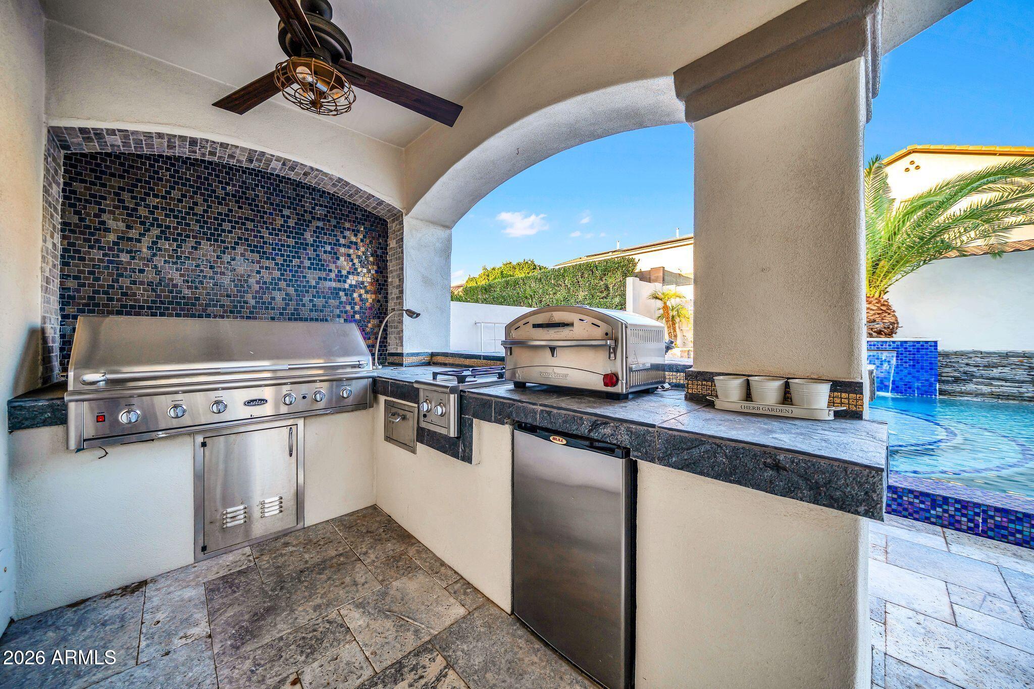 2985 North Point Ridge Road Buckeye, AZ 85396 - Photo 77 of 107 a kitchen with a sink a stove and cabinets