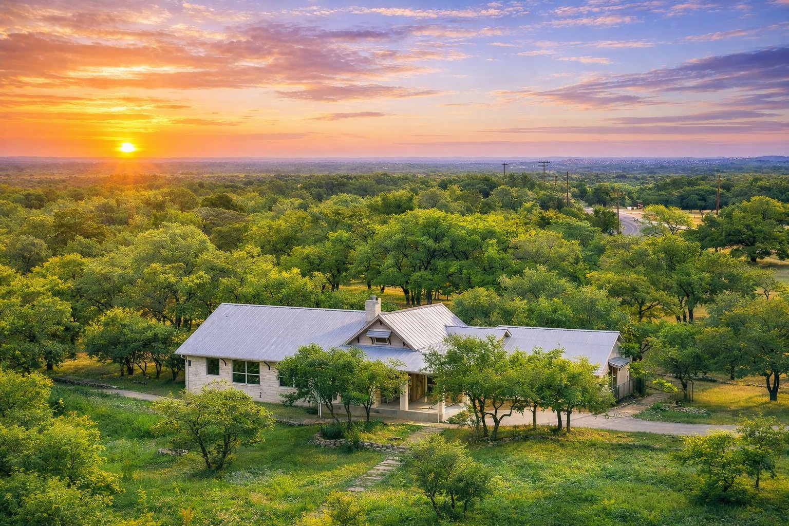 232 Crooked Oak Round Mountain, TX 78663 - Photo 2 of 40 Aerial view at dusk of a wooded view