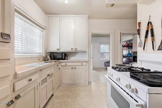 a kitchen with appliances cabinets and a sink