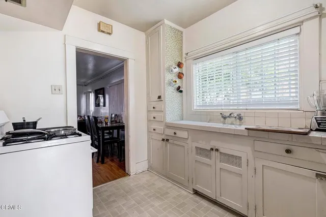 a kitchen with cabinets appliances and a window