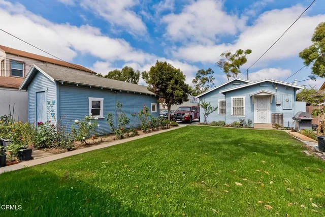 a view of a house with a flower garden