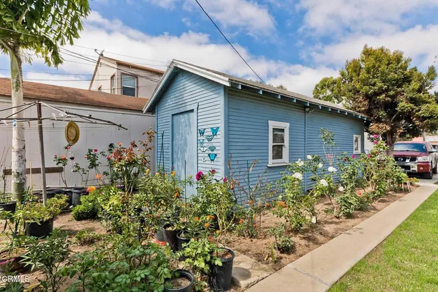 a front view of a house with a yard table and chairs