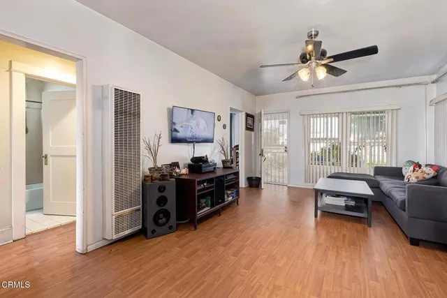 a living room with furniture and a wooden floor