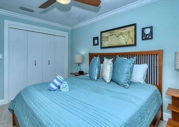 a view of a bedroom with furniture and wooden floor
