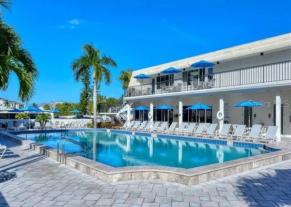 a view of a swimming pool with outdoor seating