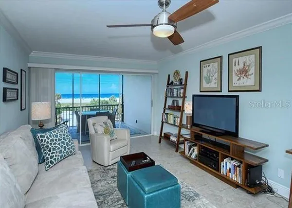a living room with furniture a ceiling fan and a window