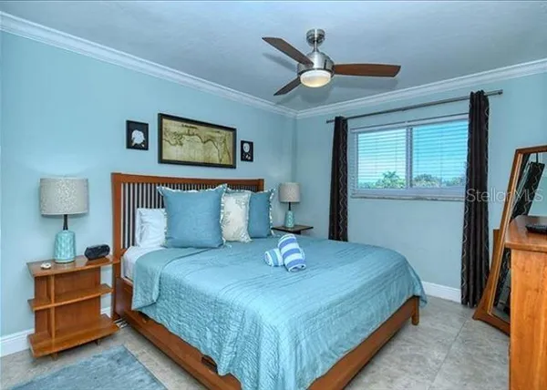 a bedroom with a bed and a lamp on table