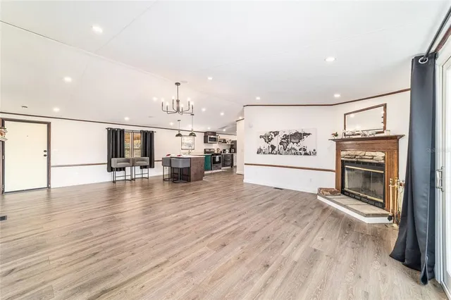 a view of a kitchen with wooden floor and electronic appliances