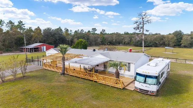 a aerial view of a house with swimming pool and lake view