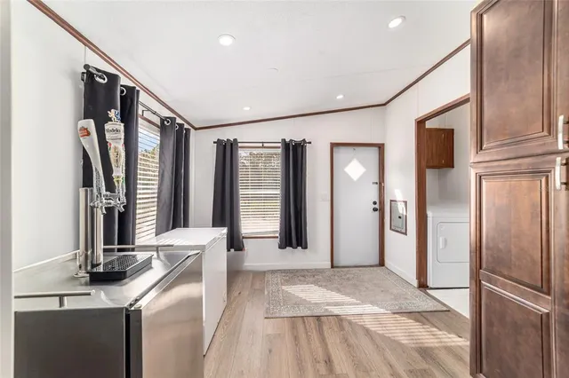 a large kitchen with stainless steel appliances kitchen island granite countertop a large counter top and wooden floors