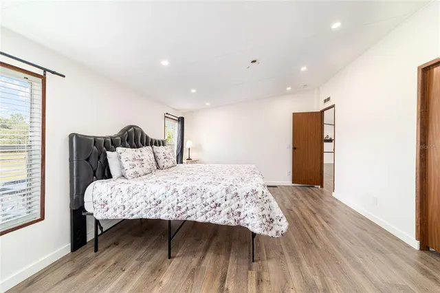 a bedroom with a bed and a chandelier