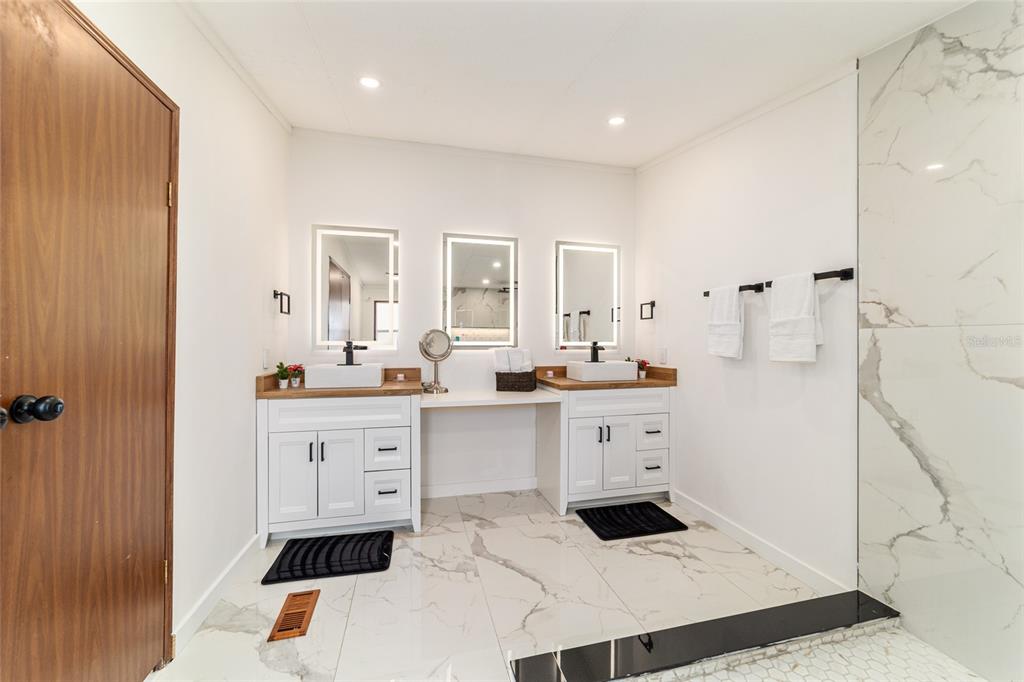 5150 Southeast 117th Avenue Morriston, FL 32668 - Photo 33 of 63 a kitchen with white cabinets and sink