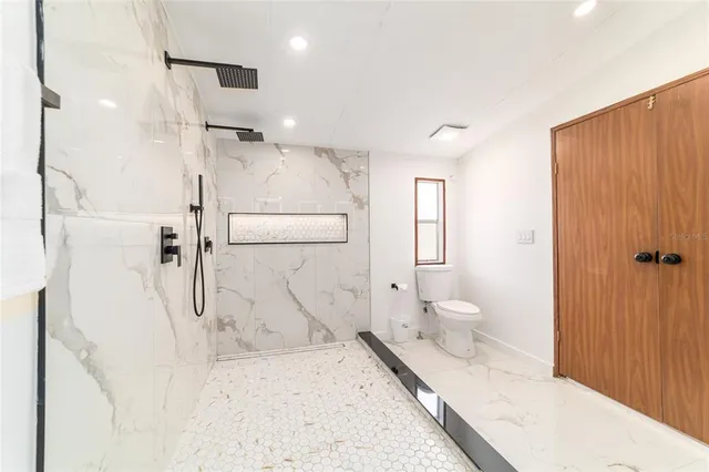 a bathroom with a sink toilet and shower