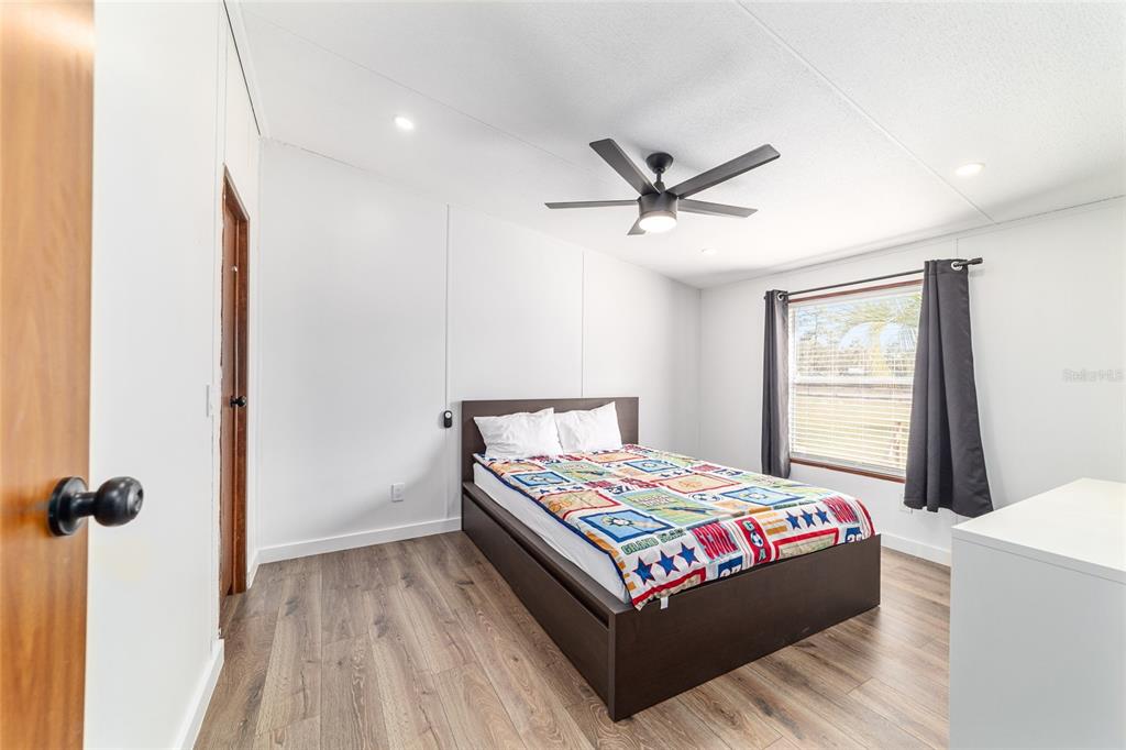 5150 Southeast 117th Avenue Morriston, FL 32668 - Photo 40 of 63 a bedroom with a bed and a chandelier