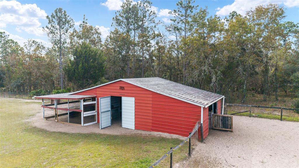 5150 Southeast 117th Avenue Morriston, FL 32668 - Photo 48 of 63 a front view of a house with swimming pool and a yard