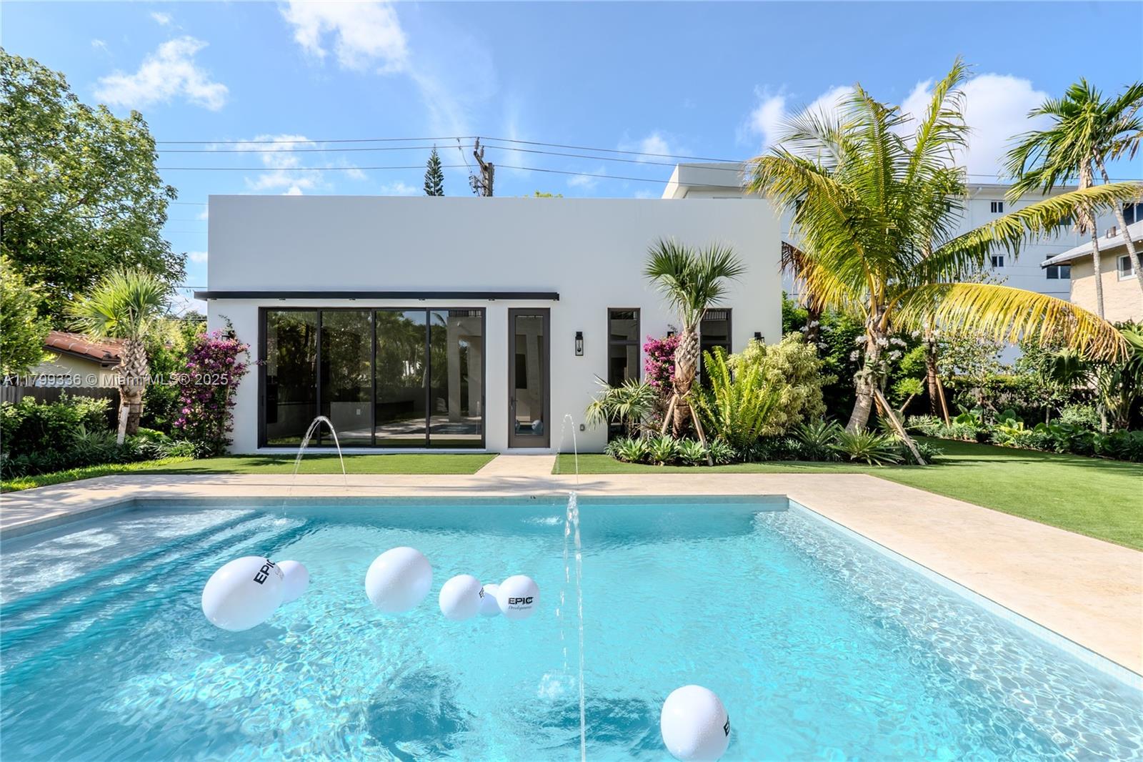 4231 Southwest 10th Street Miami, FL 33134 - Photo 28 of 35 a view of a house with a swimming pool and a yard