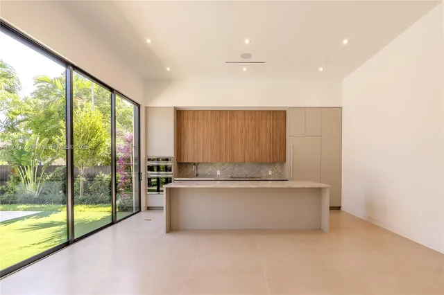 a living room with a large window and a table