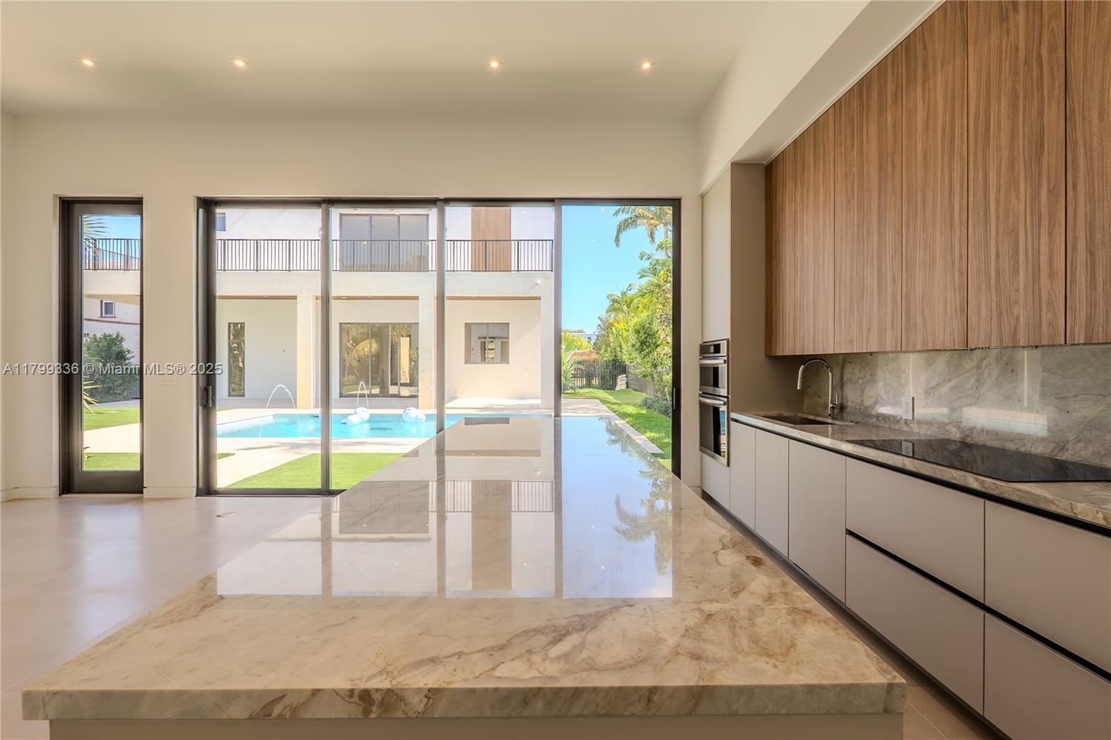 4231 Southwest 10th Street Miami, FL 33134 - Photo 31 of 35 a view of a kitchen with stainless steel appliances granite countertop a refrigerator and a sink