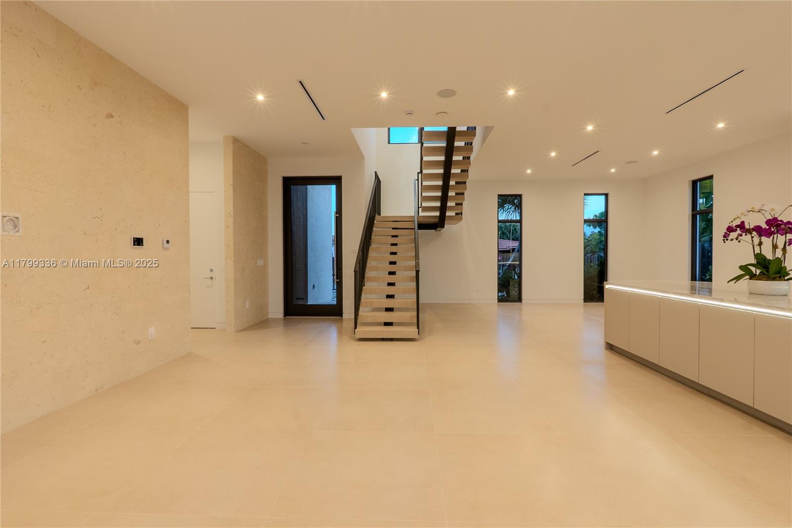 4231 Southwest 10th Street Miami, FL 33134 - Photo 6 of 35 a view of an empty room with stairs and a view of living room