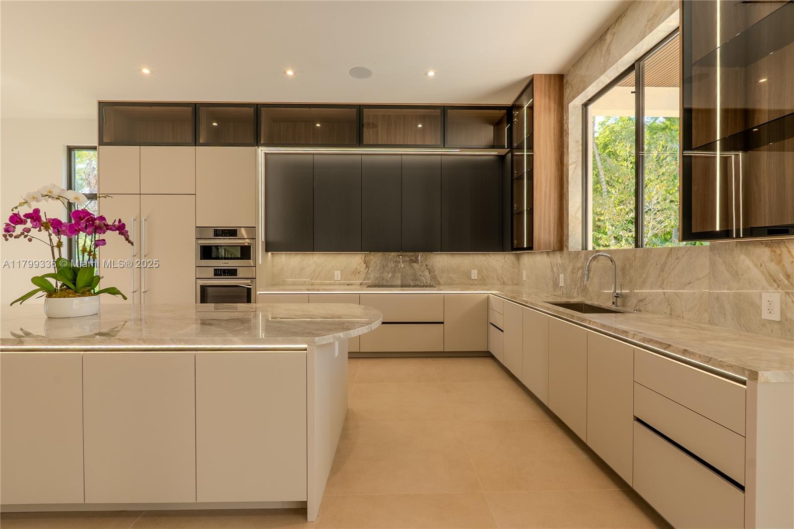 4231 Southwest 10th Street Miami, FL 33134 - Photo 10 of 35 a kitchen with stainless steel appliances kitchen island granite countertop a sink and a refrigerator