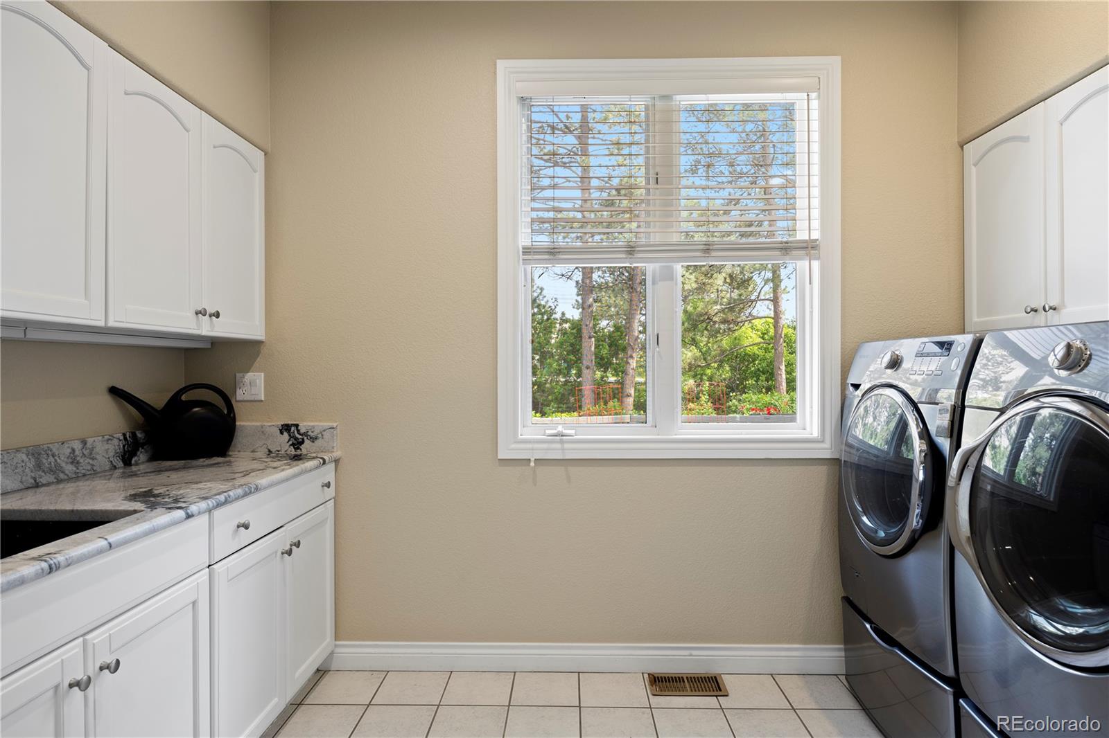 315 Prospect Drive Castle Rock, CO 80108 - Photo 21 of 45 a utility room with cabinets washer and dryer