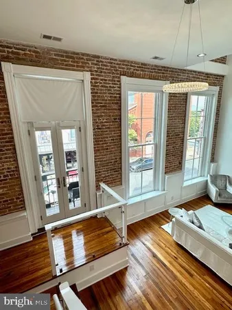 a living room with furniture window and wooden floor