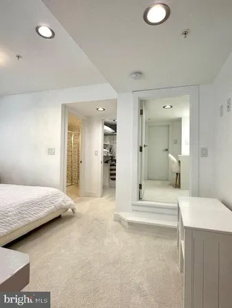 a bathroom with a sink mirror vanity and toilet