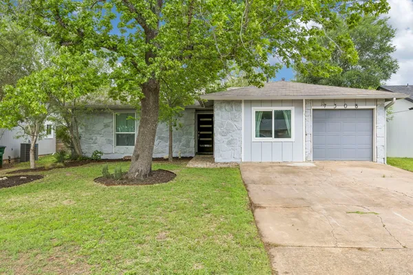 a backyard of a house with yard and tree