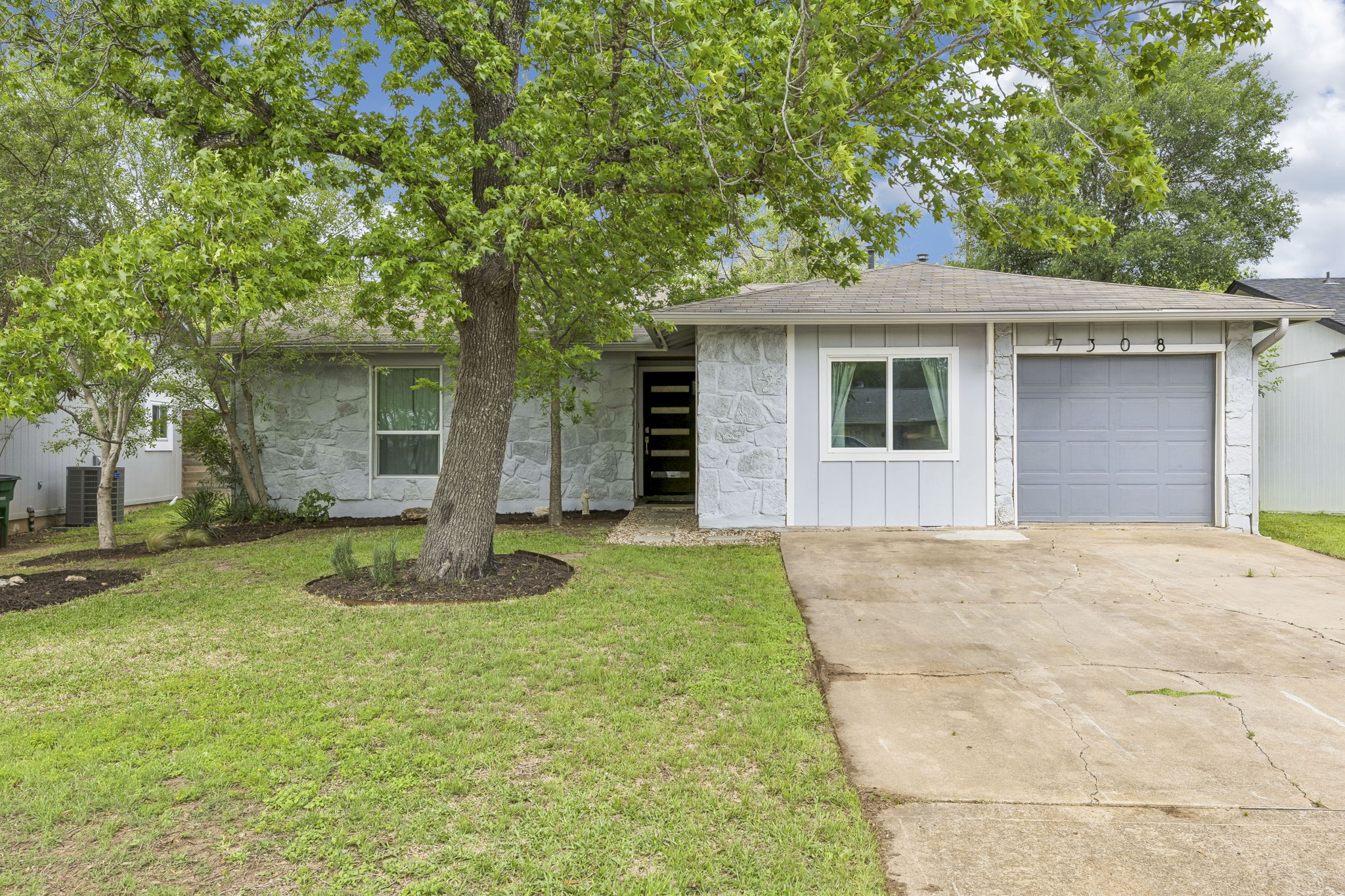a backyard of a house with yard and tree