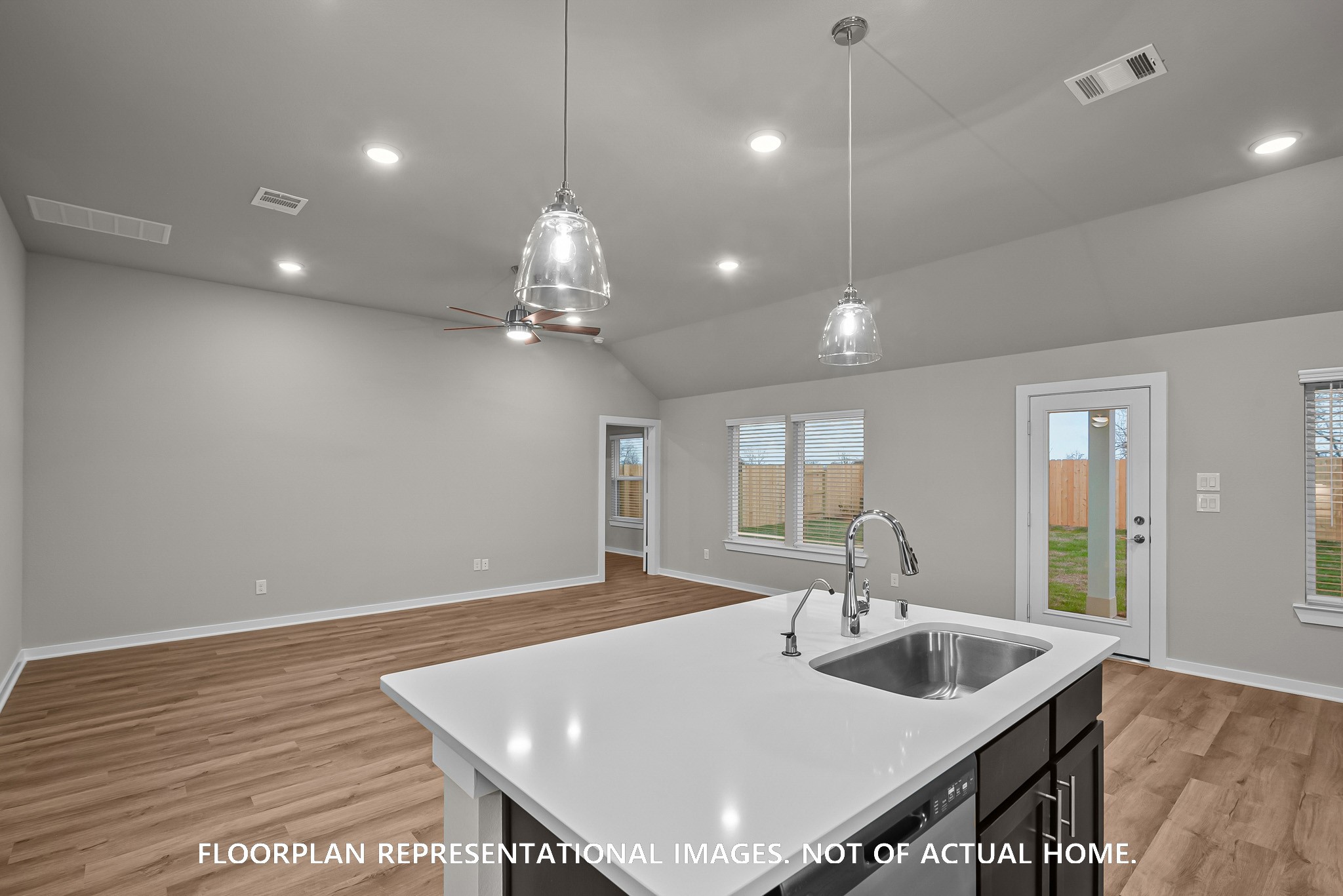 213 Draper Shadows Drive Willis, TX 77378 - Photo 3 of 19 a view of a kitchen area with furniture and wooden floor