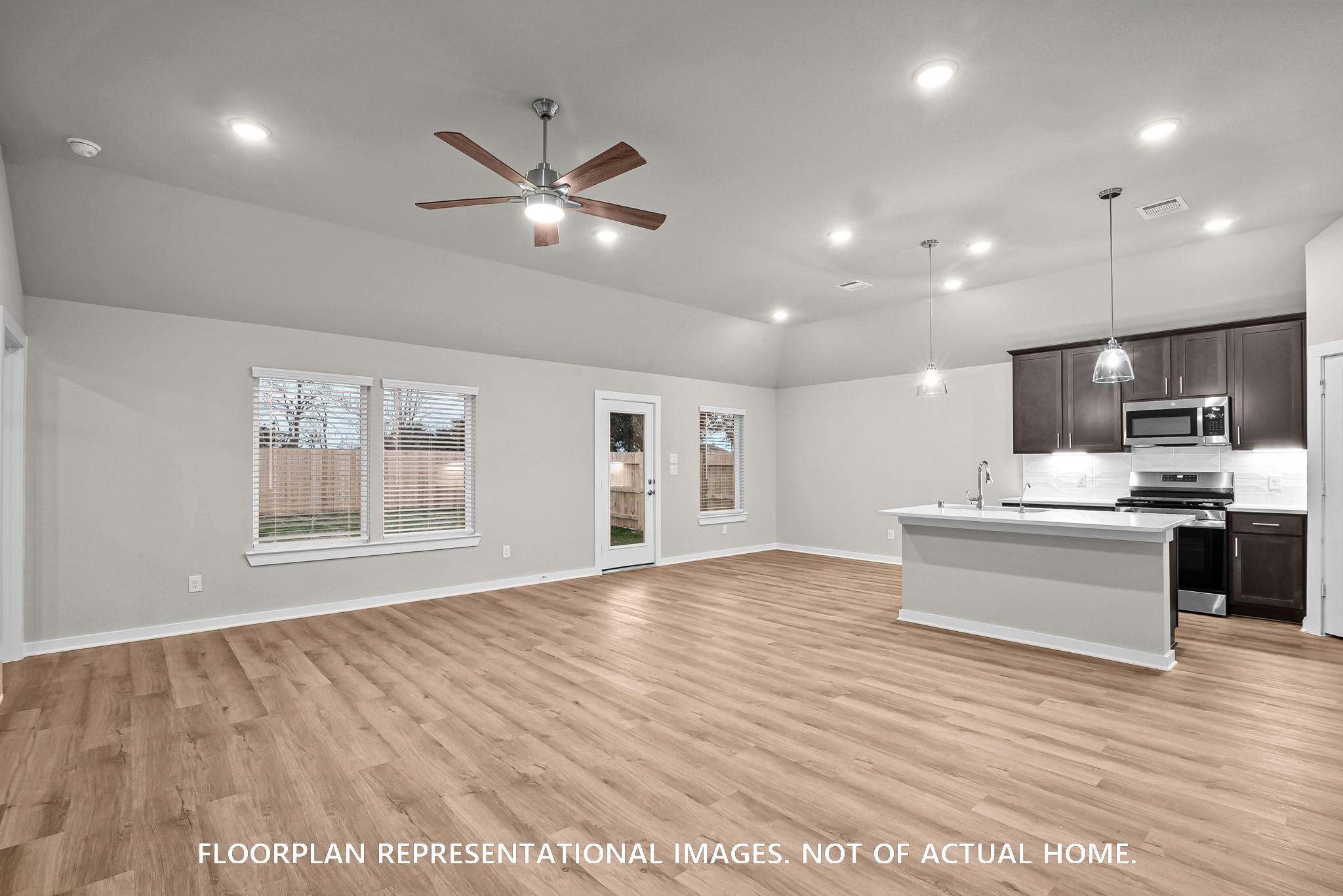 213 Draper Shadows Drive Willis, TX 77378 - Photo 6 of 19 a view of an empty room with kitchen and window