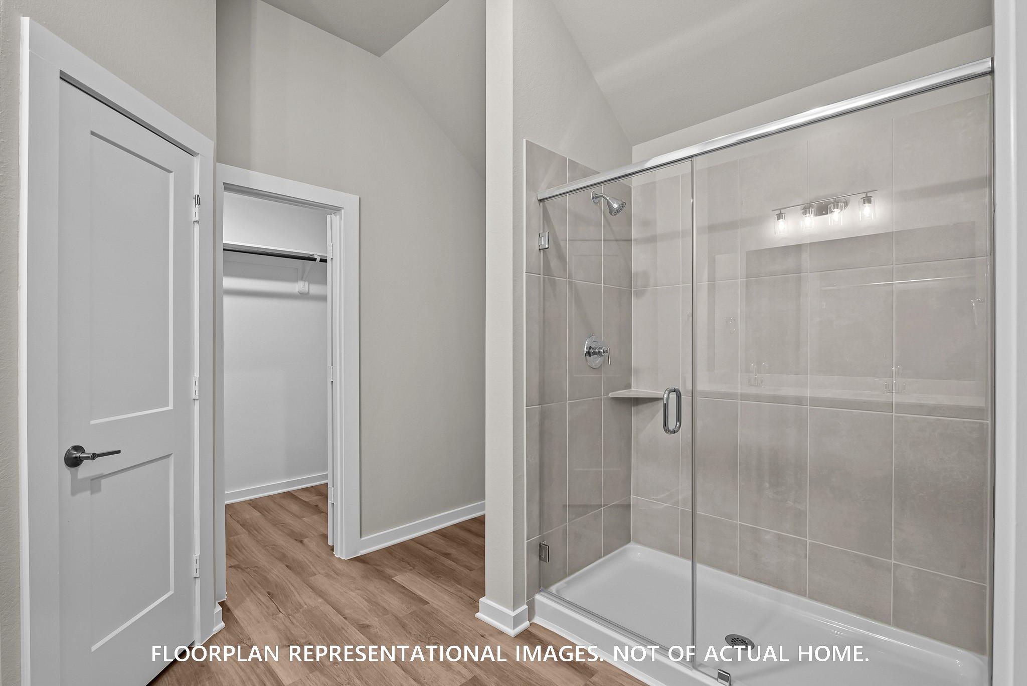 213 Draper Shadows Drive Willis, TX 77378 - Photo 8 of 19 a bathroom with a glass shower door