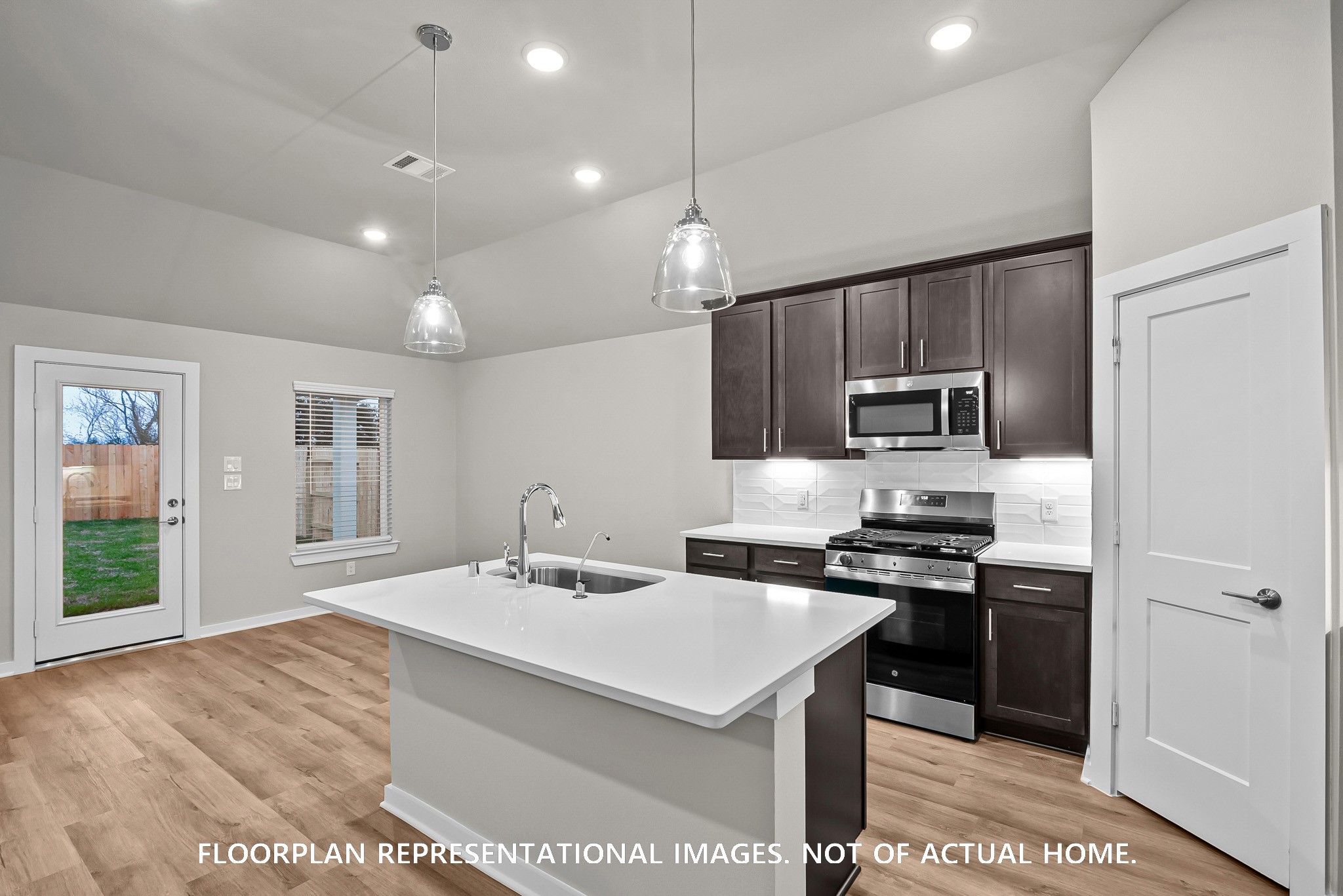 213 Draper Shadows Drive Willis, TX 77378 - Photo 9 of 19 a kitchen with stainless steel appliances a sink stove and refrigerator