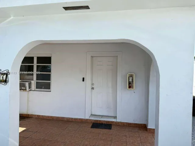 a view of an empty room and a bathroom