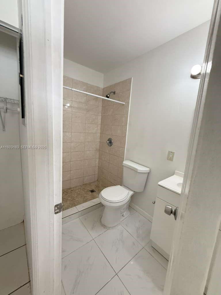 526 Southwest 64th Avenue, Unit 2 Miami, FL 33144 - Photo 6 of 9 a bathroom with a toilet and a shower