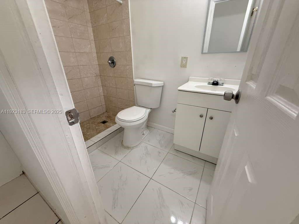 526 Southwest 64th Avenue, Unit 2 Miami, FL 33144 - Photo 8 of 9 a white toilet sitting next to a white sink