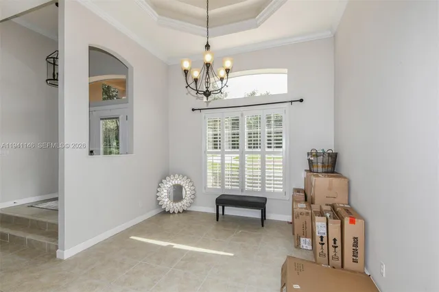 a bedroom with a bed and a chandelier fan